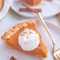 Slices of sweet potato pie on white plates