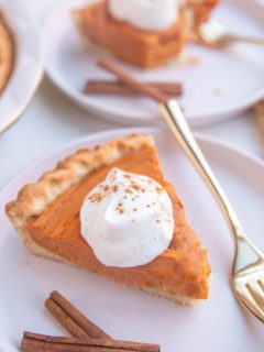 Slices of sweet potato pie on white plates