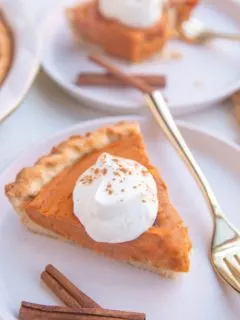 Slices of sweet potato pie on white plates