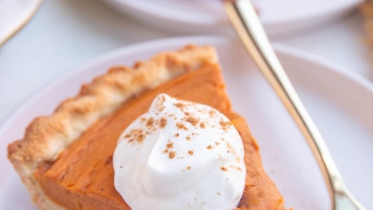 Slices of sweet potato pie on white plates