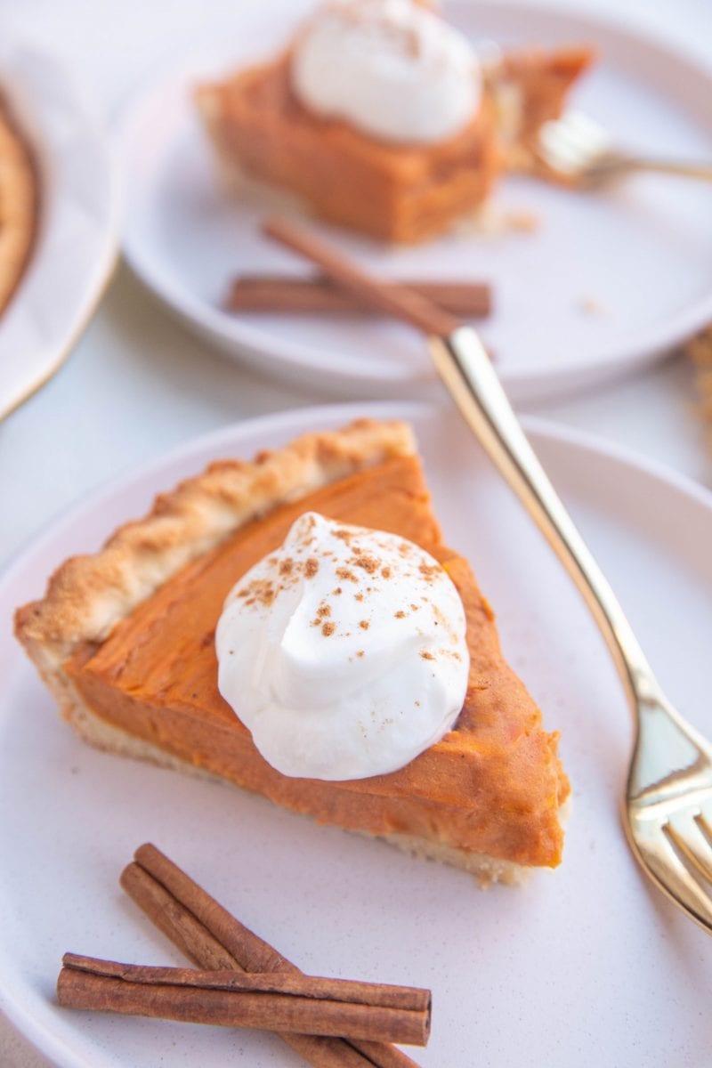 Slices of sweet potato pie on white plates