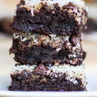 Stack of three black bean brownies on a plate, ready to eat.