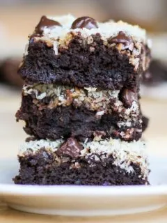 Stack of three black bean brownies on a plate, ready to eat.