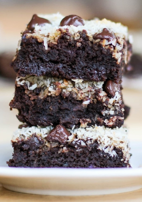Stack of three black bean brownies on a plate, ready to eat.