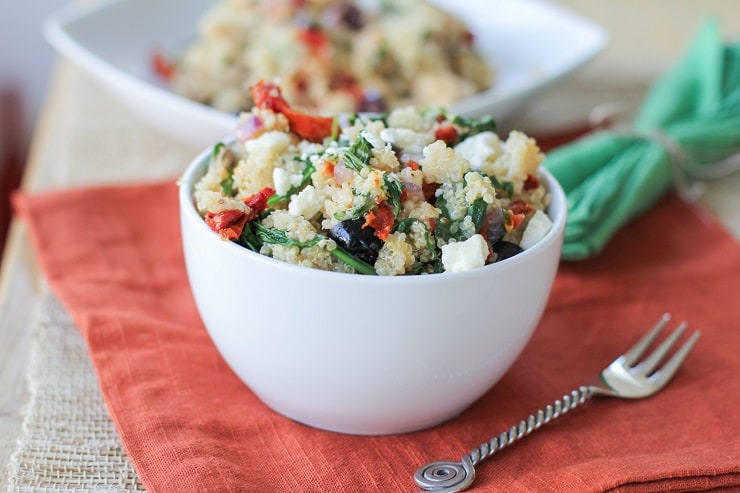 Mediterranean Quinoa Salad with spinach, kalamata olives, sun-dried tomatoes, feta, and lemon vinaigrette - a healthy vegetarian meal or side dish!