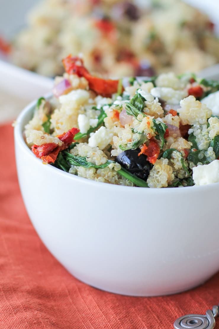 Mediterranean Quinoa Salad with spinach, kalamata olives, sun-dried tomatoes, feta, and lemon vinaigrette - a healthy vegetarian meal or side dish!