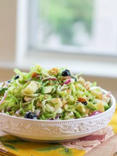 Shaved Brussels Sprouts Salad with avocado, apple, red onion, blueberries, walnuts, and citrus dressing | TheRoastedRoot.net #healthy #salad #sidedish #glutenfree #paleo #vegan