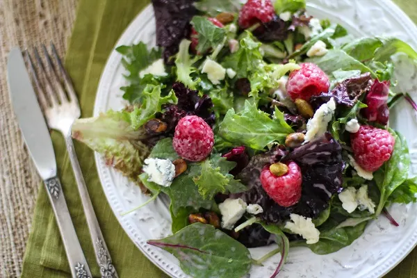 Raspberry Pistachio Salad with Creamy Raspberry Vinaigrette | https://www.theroastedroot.net