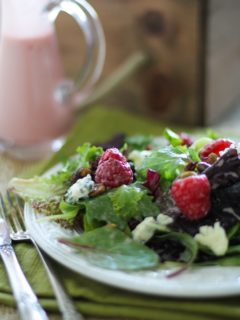 Raspberry Pistachio Salad with Creamy Raspberry Vinaigrette | https://www.theroastedroot.net