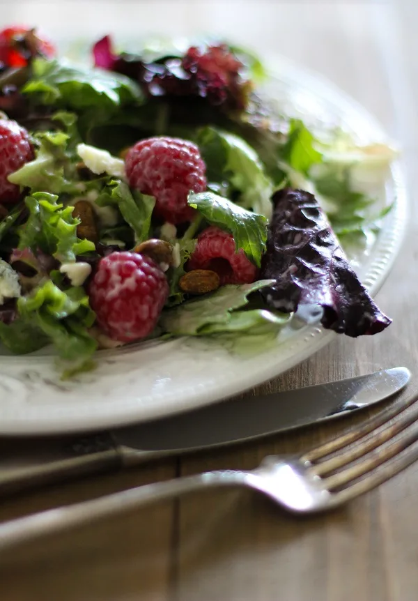 Raspberry Pistachio Salad with Creamy Raspberry Vinaigrette | https://www.theroastedroot.net