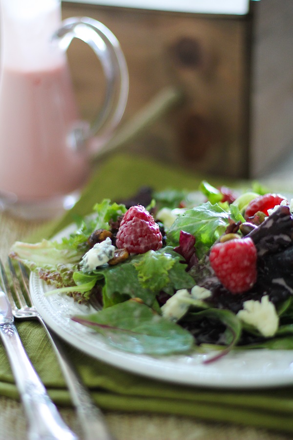 Raspberry Pistachio Salad with Creamy Raspberry Vinaigrette | https://www.theroastedroot.net