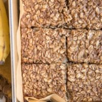 Baking pan with Banana Baked Oatmeal on top of a golden-brown napkin