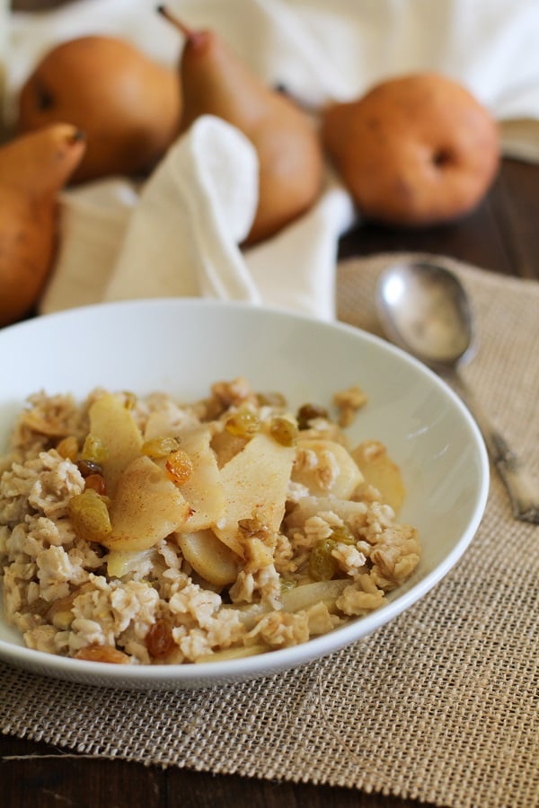 Bowl of Caramelized Pear Oatmeal with golden raisins and walnuts www.theroastedroot.net