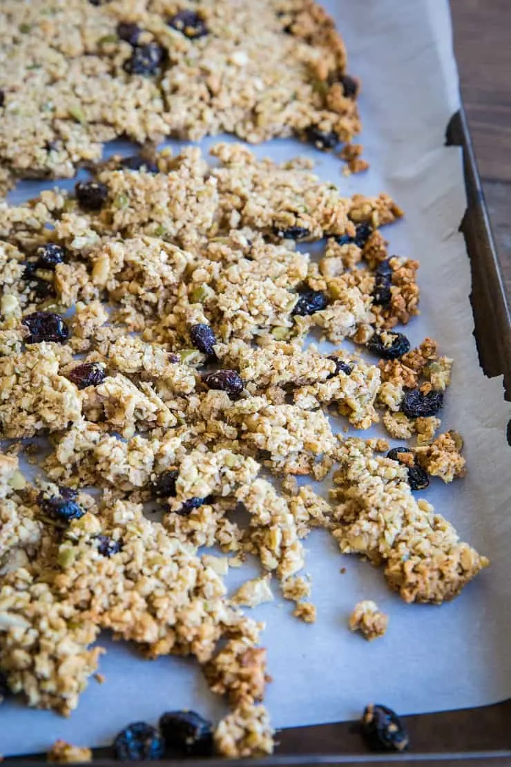 Grain-Free Paleo Granola made with nuts and seeds. This refined sugar-free recipe yields huge granola clusters and is super crunchy and delicious for breakfast or snack
