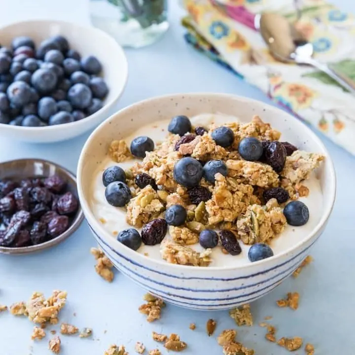 Grain-Free Paleo Granola made with nuts and seeds. This refined sugar-free recipe yields huge granola clusters and is super crunchy and delicious for breakfast