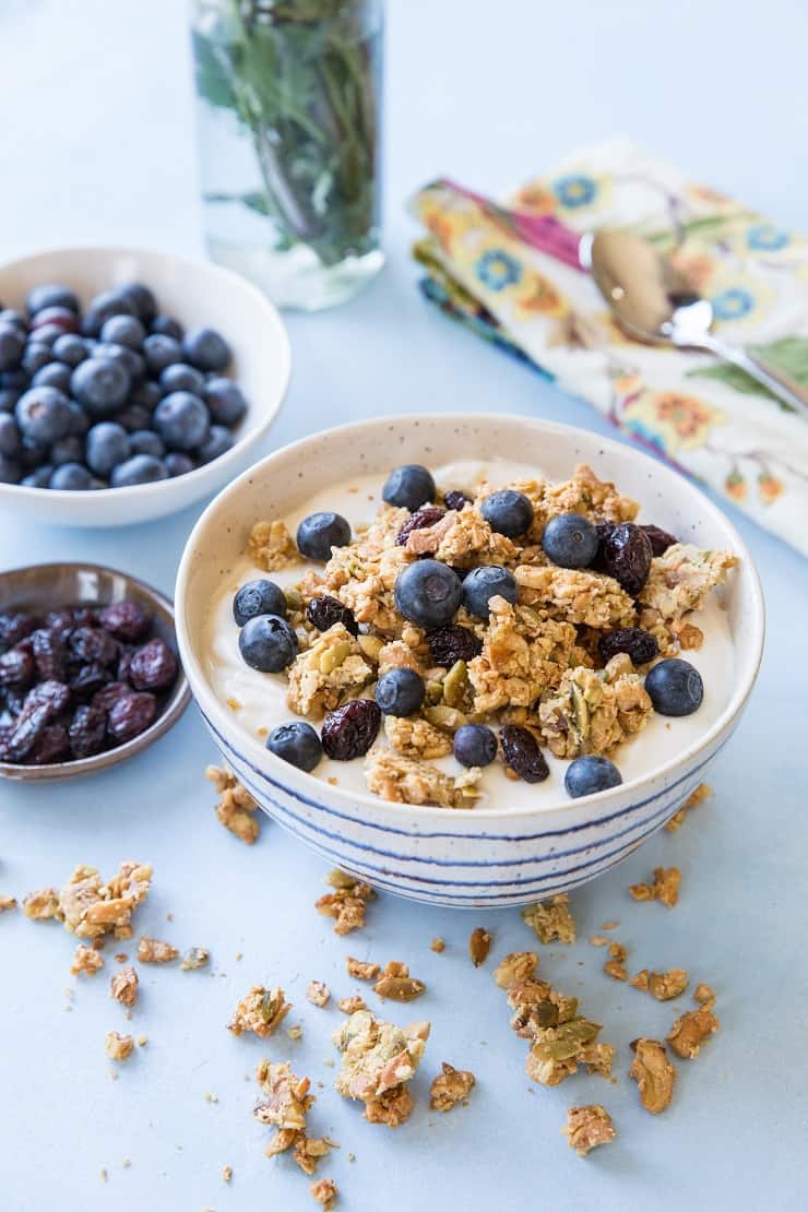 Grain-Free Paleo Granola made with nuts and seeds. This refined sugar-free recipe yields huge granola clusters and is super crunchy and delicious for breakfast