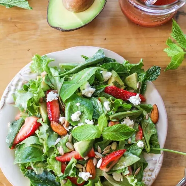 Baby Kale Salad with Strawberry-Mint Vinaigrette, goat cheese, walnuts, and avocado - a healthy and delicious summer salad recipe