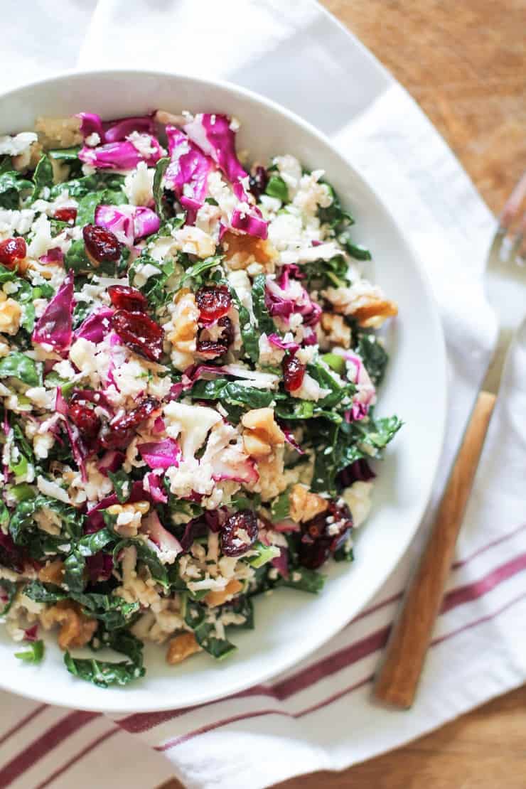 Raw Cauliflower Couscous - packed with cabbage, kale, walnuts, dried cranberries with a zesty dressing. Vegan, paleo, gluten-free, healthy!