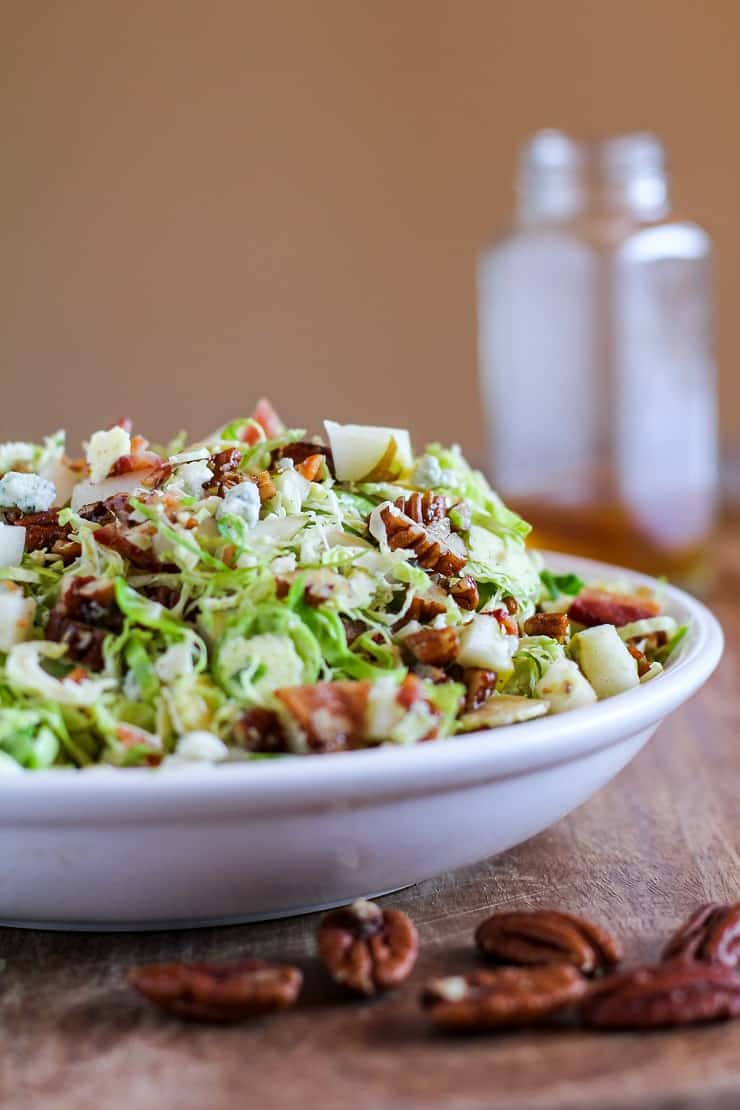 Brussel Sprout Chopped Salad with bacon, pears, candied pecans, blue cheese, and maple-bacon vinaigrette | TheRoastedRoot.com