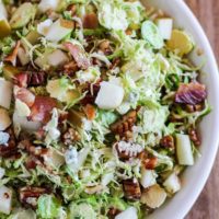 Brussel Sprout Chopped Salad with bacon, pears, candied pecans, blue cheese, and maple-bacon vinaigrette | TheRoastedRoot.com