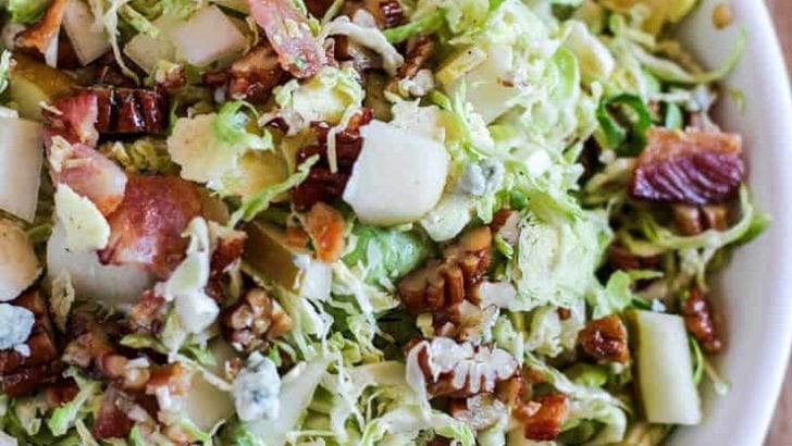 Brussel Sprout Chopped Salad with bacon, pears, candied pecans, blue cheese, and maple-bacon vinaigrette | TheRoastedRoot.com