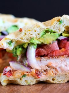 Gluten Free Jalapeño Cheddar Bacon Waffle Sandwiches with gluten-free fried chicken, mashed avocado, and chipotle yogurt sauce