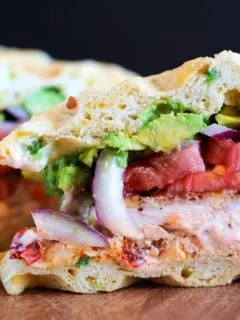 Gluten Free Jalapeño Cheddar Bacon Waffle Sandwiches with gluten-free fried chicken, mashed avocado, and chipotle yogurt sauce