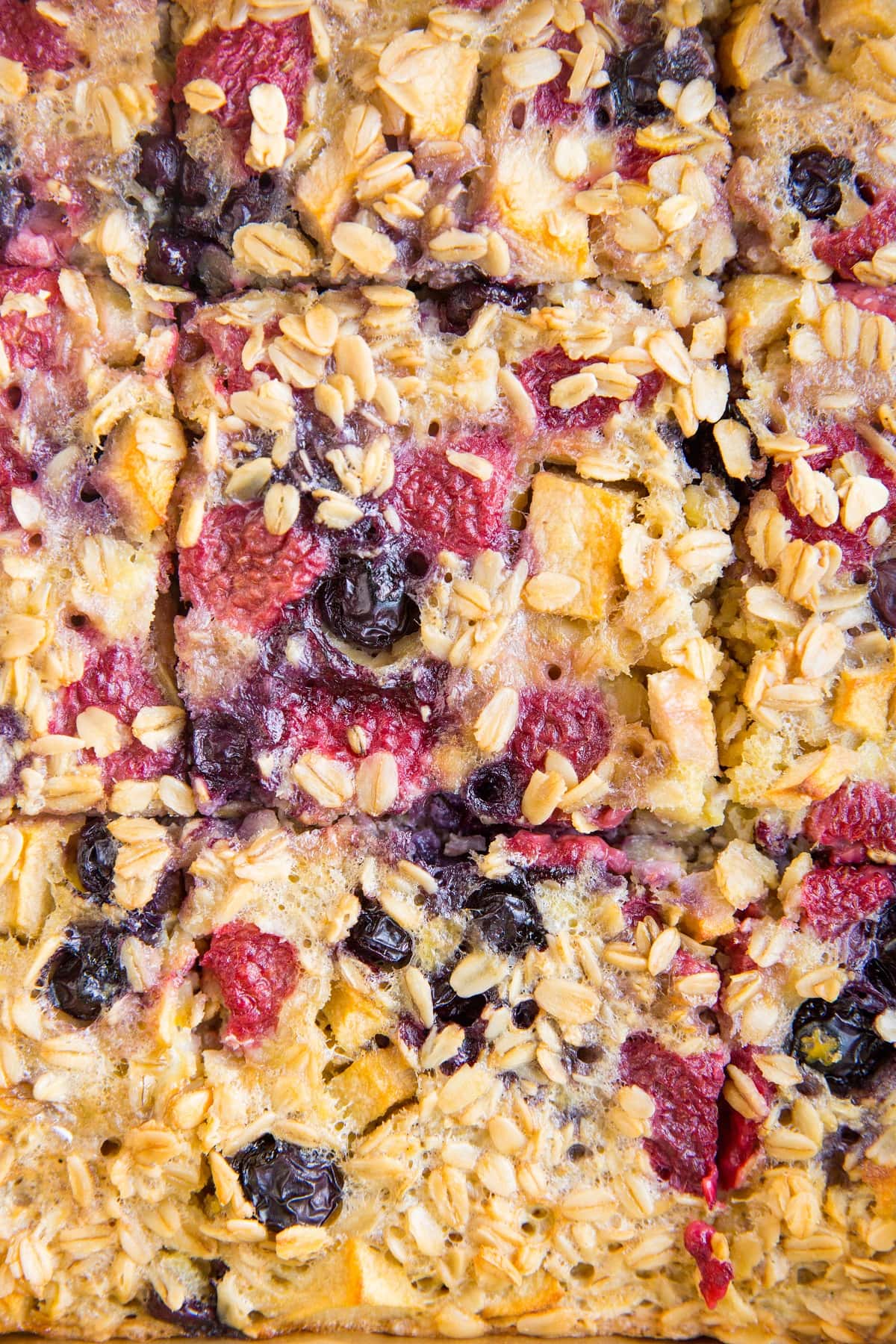 Close up image of berry baked oatmeal cut into slices.