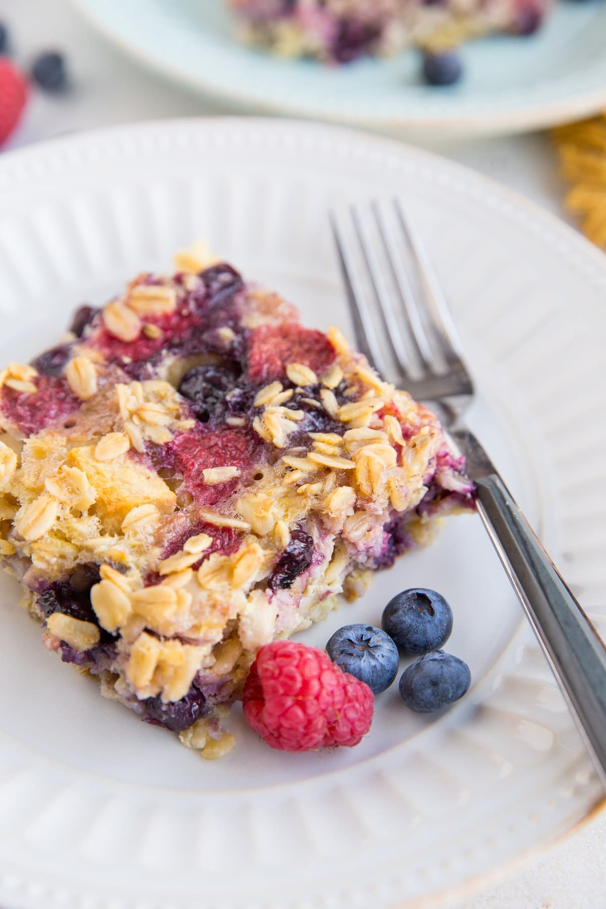 Sliced of Mixed Berry Baked Oatmeal on a plate, ready to be consumed