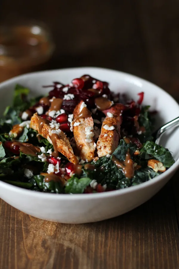 Chili Chicken Kale Salad with pomegranate seeds, pecans, goat cheese, shredded beets, and cinnamon dijon balsamic vinaigrette