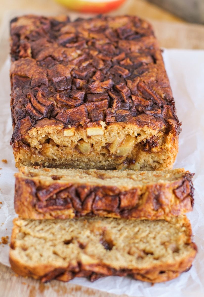 Close up of sliced loaf of apple bread, where you can see the chunks of apple and the cinnamon swirl.