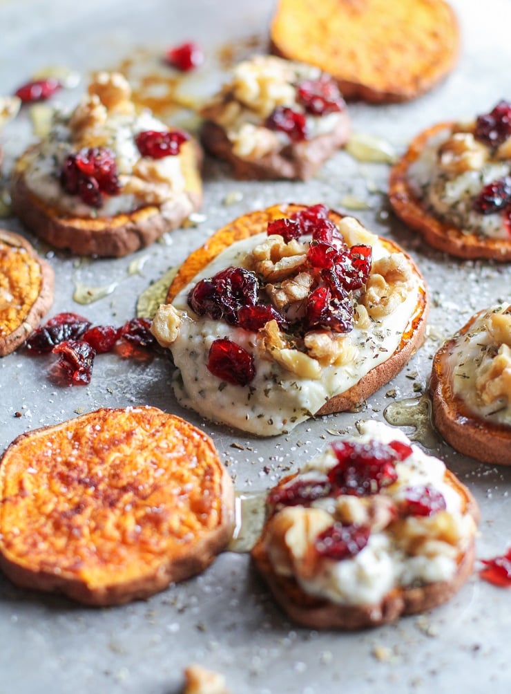 Sweet Potato Rounds with Herbed Goat Cheese, Roasted Walnuts, Cranberries, and Honey | TheRoastedRoot.net an easy and healthy appetizer! #recipe #glutenfree #healthy #holiday