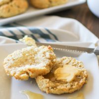 grain-free biscuit on a plate with butter and honey