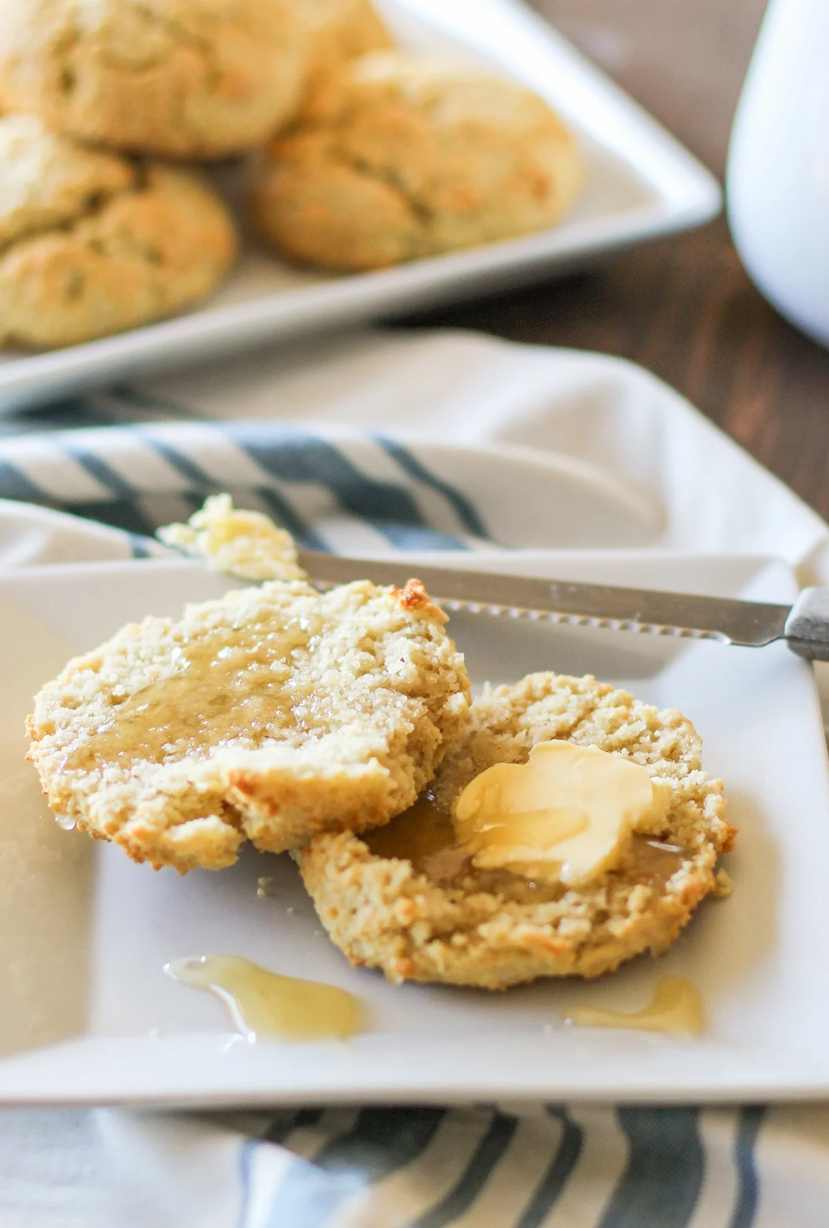 grain-free biscuit on a plate with butter and honey