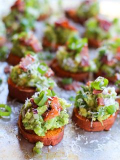 Roasted Sweet Potato Rounds with Guacamole and Bacon | theroastedroot.net #paleo #vegan #recipe #appetizer