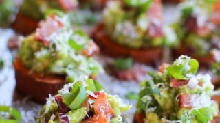 Roasted Sweet Potato Rounds with Guacamole and Bacon | theroastedroot.net #paleo #vegan #recipe #appetizer