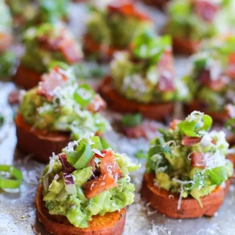 Roasted Sweet Potato Rounds with Guacamole and Bacon | theroastedroot.net #paleo #vegan #recipe #appetizer