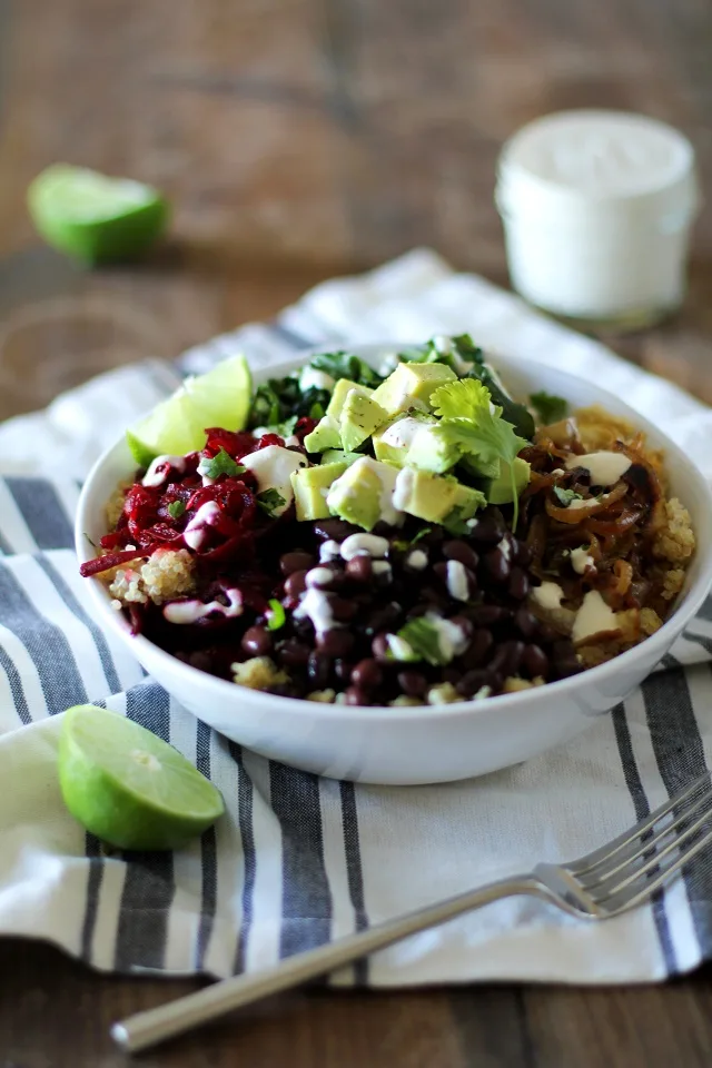 Quinoa, beet, and black bean burrito bowls with caramelized onions and cumin-lime tahini | theroastedroot.net #vegan #vegetarian #recipe #paleo #healthy @roastedroot