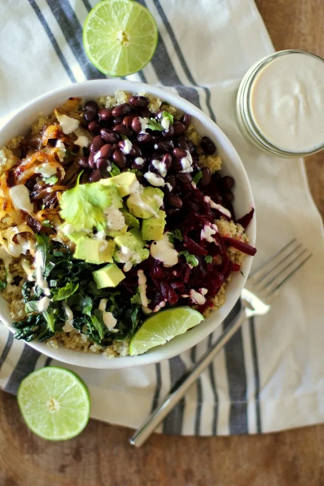 Quinoa, beet, and black bean burrito bowls with caramelized onions and cumin-lime tahini | theroastedroot.net #vegan #vegetarian #recipe #paleo #healthy @roastedroot