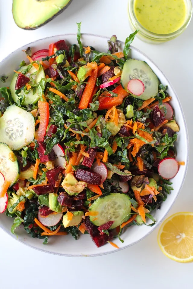 Spring Cleaning Detox Salad with kale, bell pepper, radishes, carrots, beets, avocado, walnuts, and lemon-parsley vinaigrette | theroastedroot.net #vegan #vegetarian #detox #salad #cleaneating #letthemeatkale