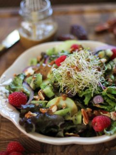 Spring Green Salad with kiwi, raspberries, cucumbers, sprouts, pecans, and date-balsamic vinaigrette | theroastedroot.net #vegetarian #recipe #healthy