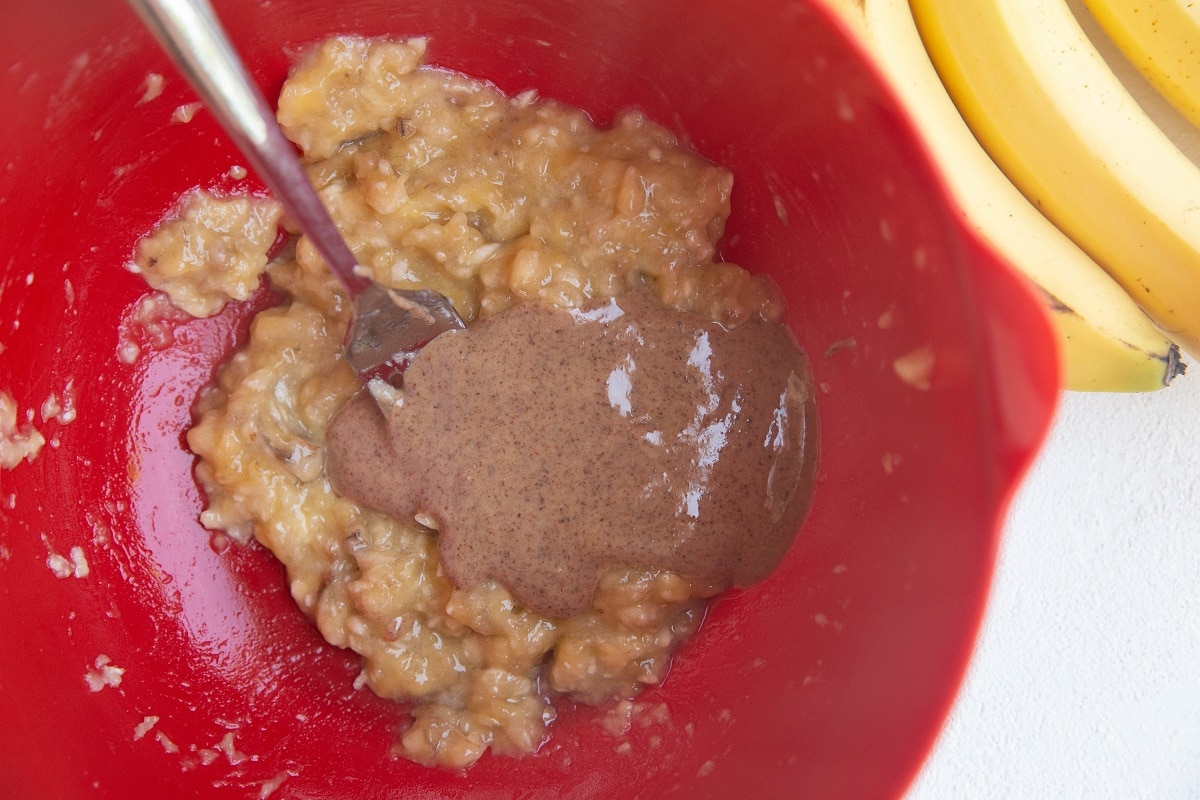 Mixing bowl with mashed banana and almond butter