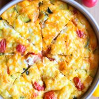 Goat Cheese, Tomato, and Zucchini Frittata in a baking pan.
