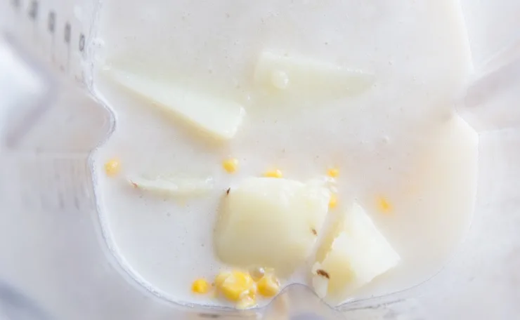 Make corn chowder broth by blending coconut milk, corn, and potatoes in a blender