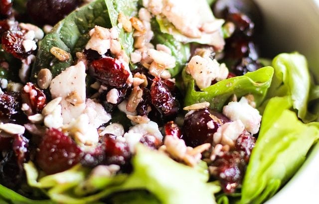 Spinach Salad with sunflower seeds, dried cranberries, grapes, feta cheese, and raspberry vinaigrette | TheRoastedRoot.net #healthy #recipe #vegetarian