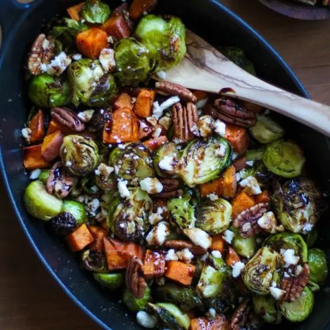 Roasted Brussels Sprouts and Sweet Potatoes with Pecans, Feta, and Balsamic Reduction | TheRoastedRoot.net #healthy #vegetarian