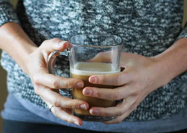 Bulletproof Coffee - brewed coffee + grassfed butter + coconut oil blended together in a blender makes a frothy latte! | TheRoastedRoot.net #paleo #recipe #healthy #drink