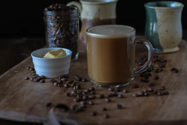 Bulletproof Coffee - brewed coffee + grassfed butter + coconut oil blended together in a blender makes a frothy latte! | TheRoastedRoot.net #paleo #recipe #healthy #drink