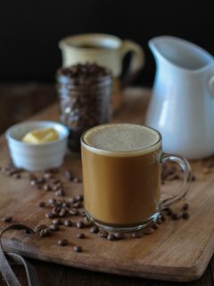 Bulletproof Coffee - brewed coffee + grassfed butter + coconut oil blended together in a blender makes a frothy latte! | TheRoastedRoot.net #paleo #recipe #healthy #drink