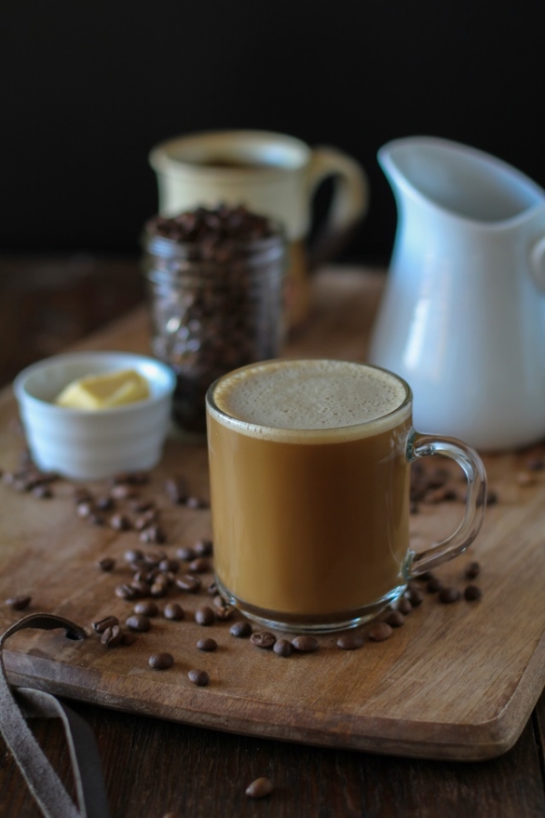 Bulletproof Coffee - brewed coffee + grassfed butter + coconut oil blended together in a blender makes a frothy latte! | TheRoastedRoot.net #paleo #recipe #healthy #drink